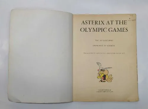 Asterix comic, Olympic Games, vintage comic, 1985 comic, French comic, collector edition, comic book, adventure comic, humor comic, Hodder Dargaud, satirical comic, classic comic, collectible comic, classic graphic novel, English edition, historic comic, comic series, illustrated edition, old comic, Olympic story, Goscinny Uderzo, comic fandom, British comic, comic marketplace, rare comic, comic lovers, comic shop, comic readers, European comic, comic book fan, comic display, comic art, 1980s comic, legendary characters, original artwork, British edition, language English, comic trading, comic auction, original paperback, 12th impression, illustrated book, best selling comic, rare finds, classic adventure, Olympic humor, humorous comic, classic story, comic collector, sports adventure, satirical graphic novel, iconic comic, Paris edition, Asterix and Obelix, adventure story, timeless comic, iconic adventure, Olympic themed comic, adventure book, satirical book, illustrator Uderzo, bestseller comic, collector’s comic, classic champion, cartoon adventure, Europe comic, Olympics themed comic, classics of humor, graphic storytelling, comic book marketplace, British comic release, rare edition, classic European comic, old edition, sports comic, Olympic adventure, funny comic, classic collectible, 1985 edition, best comics, Olympic satire, first print, comic retro, comic culture, Olympic event comic, comic treasure, comic legacy, legendary illustrator, historic graphic novel, cartoon comic, witty adventure, original edition, comic book vintage, classic humor